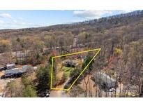 Aerial view showcasing property lines in a wooded setting with a house, yard, and neighborhood visible at 4793 Appaloosa Ln, Maiden, NC 28650