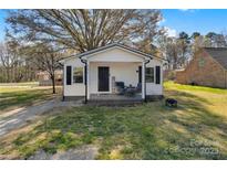 Charming one-story home with black shutters, covered porch, and green lawn at 501 S Inman Ave, Bessemer City, NC 28016