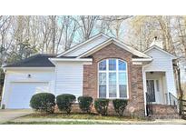 Charming single-story home with brick accents, a two-car garage, and a welcoming entrance at 5016 Haybridge Rd, Charlotte, NC 28269