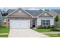 Charming single-Gathering home with brick and siding accents, a two-car garage, and a well-manicured front yard at 7015 Jerimoth Dr, Charlotte, NC 28215
