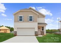 Charming two-story home featuring a two-car garage, stone accents, and well-manicured lawn at 706 Olde England Dr, Lincolnton, NC 28092