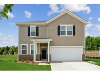 Charming two-story home with a two-car garage, green lawn, and inviting front entrance at 719 Olde England Dr, Lincolnton, NC 28092