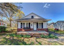 Charming one-story home with a cozy front porch and swing at 100 W 3Rd St, Cherryville, NC 28021