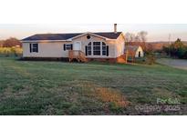 Charming single-story home with a well-maintained lawn, wooden porch, and classic black shutters at 1524 J Rhyne Reep Rd, Vale, NC 28168