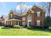 Charming brick two-story home with manicured lawn and beautiful landscaping at 16123 Chiltern Ln, Huntersville, NC 28078