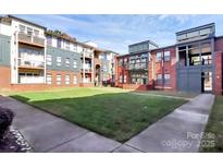 Exterior of a brick building with a view of the grassy courtyard at 474 New Bern Station Ct, Charlotte, NC 28209
