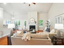 Bright living room with hardwood floors, a fireplace, and neutral decor for a relaxing atmosphere at 5032 Eagles Crest Ln, Gastonia, NC 28056