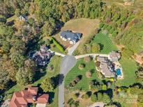 Overhead view of a neighborhood featuring modern homes with a lush, wooded backdrop at 5039 Eliza Long Wilkie Dr, Huntersville, NC 28078