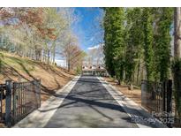 Long driveway leading to a charming home with a inviting porch and beautiful landscaping at 8172 Summit Ridge Dr, Catawba, NC 28609