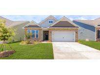 Charming single-story home boasts stone accents, a two-car garage, and a well-manicured lawn at 120 S Shayna Rd, Troutman, NC 28166