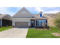Charming single-story home with a well-manicured lawn, neutral paint, and an attached garage at 122 N Shayna Rd, Troutman, NC 28166