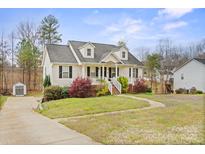Charming two-story home with a welcoming front porch and well-maintained landscaping at 123 Scotch Irish Ln # 136, Troutman, NC 28166