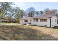 Charming single-story home featuring a lovely landscaped yard and a convenient attached garage at 1315 Vickie Ln, Matthews, NC 28104