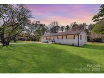 Charming single-story home with a well-manicured lawn and a lovely, inviting exterior at 1315 Vickie Ln, Matthews, NC 28104