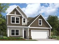 Inviting two-story home showcasing a white garage door, neutral siding, and a tastefully landscaped front yard at 2018 Puddle Pond Rd, Indian Trail, NC 28079
