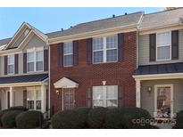 Inviting brick townhome featuring a well-maintained lawn and neutral exterior trim at 3048 Misty Harbor Cir # E, Cramerton, NC 28032