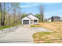 Charming, newly built single-story home with a concrete driveway and a grey garage door at 3642 Main Nw Ave, Hickory, NC 28601