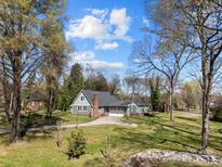 Charming single-story home with lush front yard, mature trees, and attached two-car garage at 3647 Glen Haven Sw Dr, Concord, NC 28027