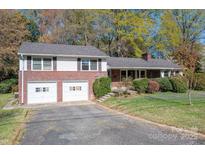 Charming two-story home featuring a brick facade, two-car garage, and well-maintained landscaping at 521 Hawthorne Ln, Gastonia, NC 28054