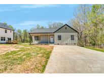 Charming single-story home featuring a concrete driveway and manicured lawn on a sunny day at 79 36Th Nw St, Hickory, NC 28601