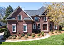Stunning brick home boasts meticulous landscaping and architectural details like arched windows at 880 Craigmont Nw Ln, Concord, NC 28027
