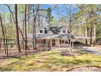 Charming brick home with a well-maintained front yard and a convenient covered parking area at 9200 Surrey Rd, Mint Hill, NC 28227