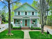 Charming two-story home with a inviting front porch, lush lawn, and traditional architectural details at 110 Sonnys Way, Fort Mill, SC 29708