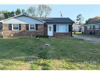 Charming single-story brick home featuring a well-manicured lawn and a welcoming front door at 1108 Pearson Dr, Rock Hill, SC 29730
