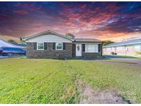 Charming brick home features an inviting front yard and black window shutters at 1108 Pearson Dr, Rock Hill, SC 29730