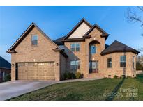 Charming brick home featuring a well-manicured lawn, a two-car garage, and a classic architectural design at 1358 37Th Avenue Ne Pl, Hickory, NC 28601