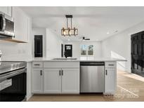 Modern kitchen features stainless appliances, white cabinetry, and a breakfast bar with sleek countertops at 2120 Green Oak Dr, Shelby, NC 28152
