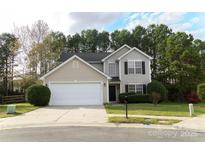 Charming two-story home featuring manicured front yard and attached two-car garage with large driveway at 2919 Bridgeville Ln, Charlotte, NC 28262