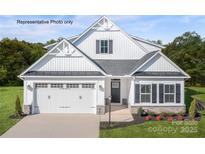 Charming two-story home with a two-car garage, manicured lawn, and classic white facade at 3008 Bramble Hedge Dr # 3272, Indian Trail, NC 28079