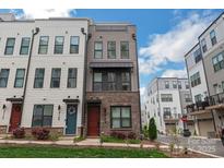 Charming three-story townhome with modern design elements and well-maintained landscaping at 3105 Beans Blvd, Charlotte, NC 28203