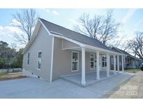 Inviting exterior view of a single-story home featuring a cozy front porch with white columns at 333 City Ave, Lancaster, SC 29720
