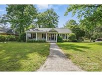 Charming single-story home with well-maintained lawn and brick pathway at 5400 Glenham Dr, Charlotte, NC 28210