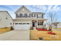 Charming two-story home with a two-car garage and beautifully landscaped front yard at 7266 Waterwheel Sw St, Concord, NC 28025