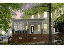 Charming two-story home with a welcoming front porch, brick base and ample natural light at 734 E 10Th St, Charlotte, NC 28202