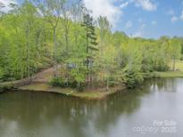 Secluded home nestled among mature trees and a tranquil lake creating a peaceful setting at 807 And 809 Sparrow Springs Rd, Kings Mountain, NC 28086