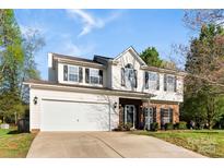 Charming two-story home featuring white siding, a two-car garage, and a well-maintained lawn at 9845 Dauphine Dr, Charlotte, NC 28216