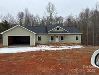 Charming one-story home with an attached two car garage, set on a spacious lot with a new front porch at 1127 Mckay Rd, Newton, NC 28658