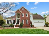 Charming brick front exterior with well-manicured lawn, inviting entrance, and attached two-car garage at 1214 Foxfield Rd, Waxhaw, NC 28173