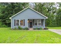 Charming single-story home with a well-manicured lawn, dark shutters, and inviting front porch at 1320 Beaconfield Ct, Rock Hill, SC 29730