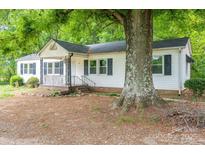 Charming single-story home with white siding, black shutters, and a covered front porch at 201 Lee Black Rd, Cherryville, NC 28021