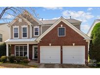 Charming two-story home featuring a combination of brick and siding, complemented by a well-maintained front lawn and landscaping at 2319 Arbor Vista Dr, Charlotte, NC 28262