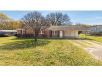 Charming brick ranch home featuring a convenient carport and a well-maintained front lawn at 260 Trexler Ln, Rock Hill, SC 29732