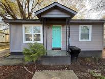 Charming home featuring a vibrant blue front door and gray siding at 3316 Queens Ln # 10, Gastonia, NC 28052