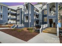 Beautiful condominium exterior showcasing blue siding, white trim, and well-maintained landscaping at 336 Northwest Dr, Davidson, NC 28036