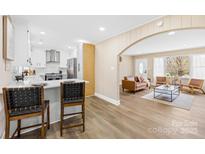 Bright living room and kitchen area with stainless steel appliances and hardwood style floors at 504 Katherine Ave, Kings Mountain, NC 28086