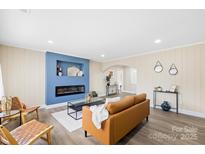Cozy living room with an electric fireplace, hardwood floors, and stylish modern decor at 504 Katherine Ave, Kings Mountain, NC 28086